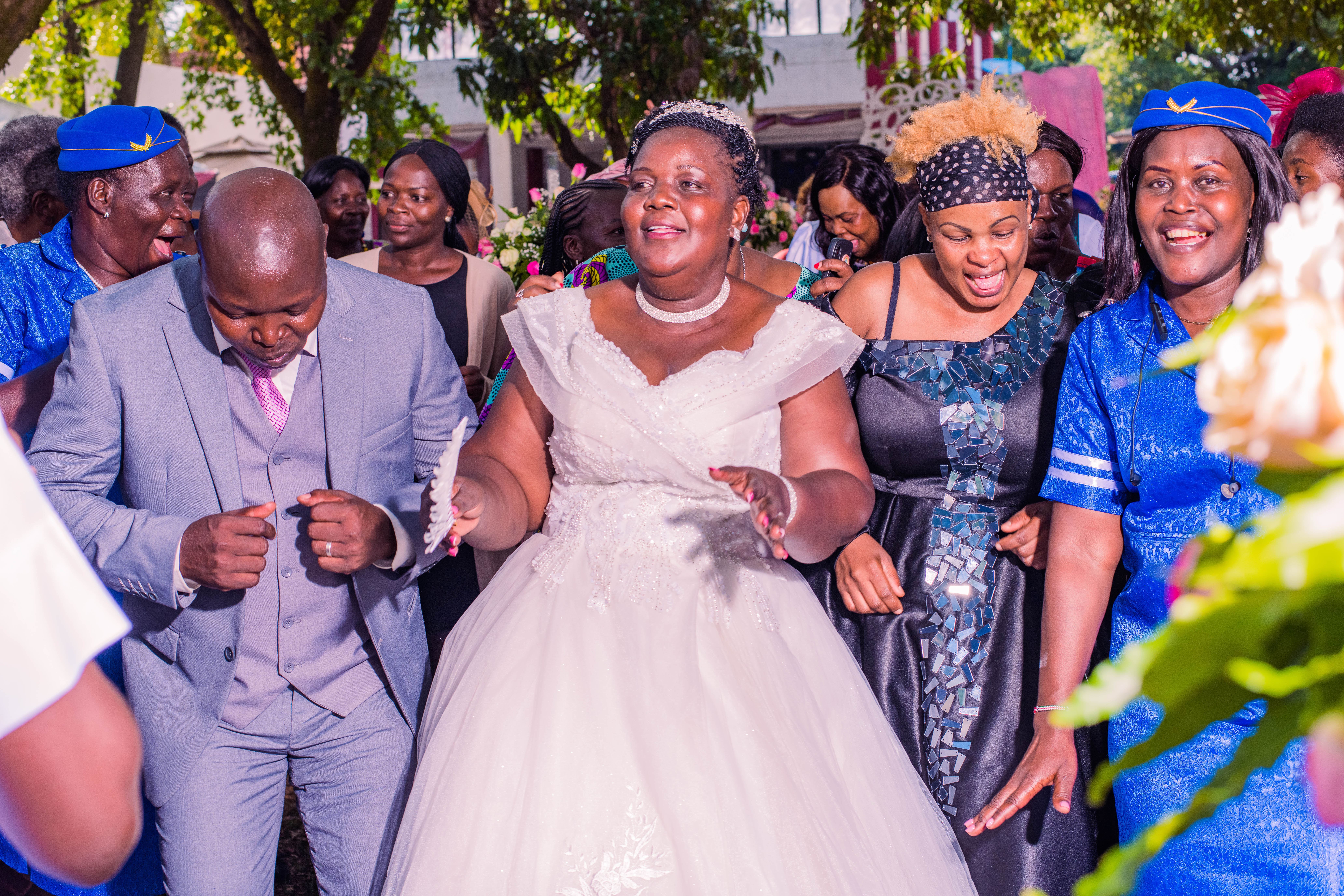 Mercy and Stephen dancing with guests at their outdoor wedding in Kisumu